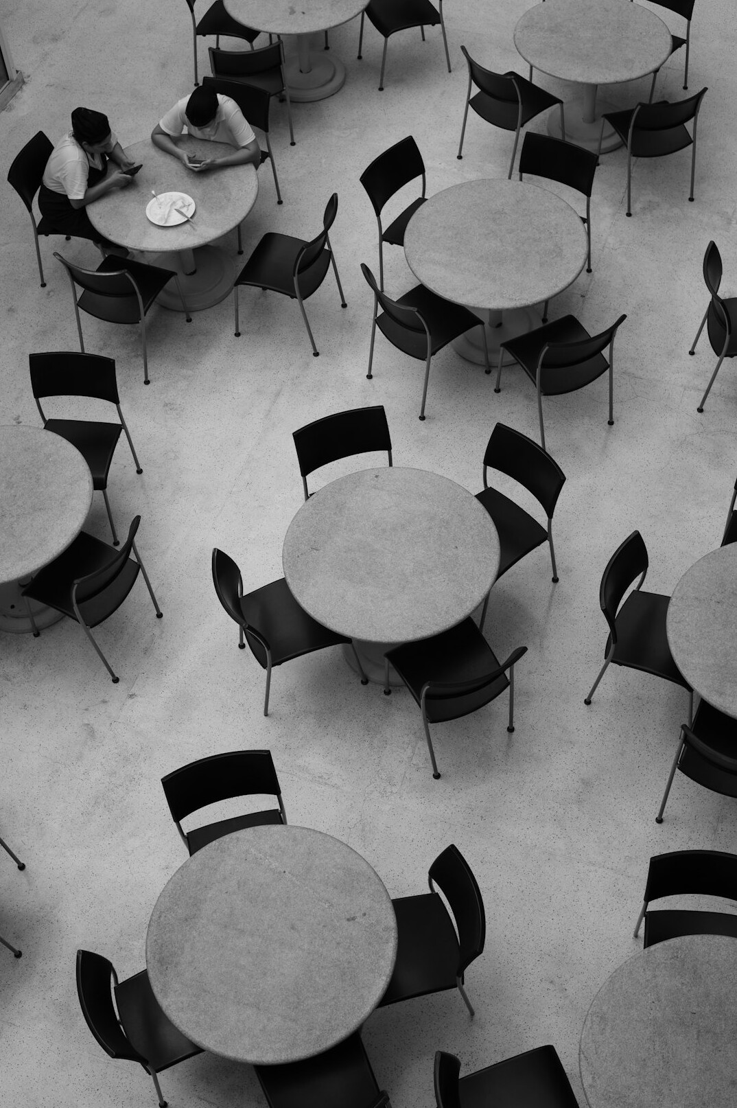 Round table prepared for a workshop with laptops and notes