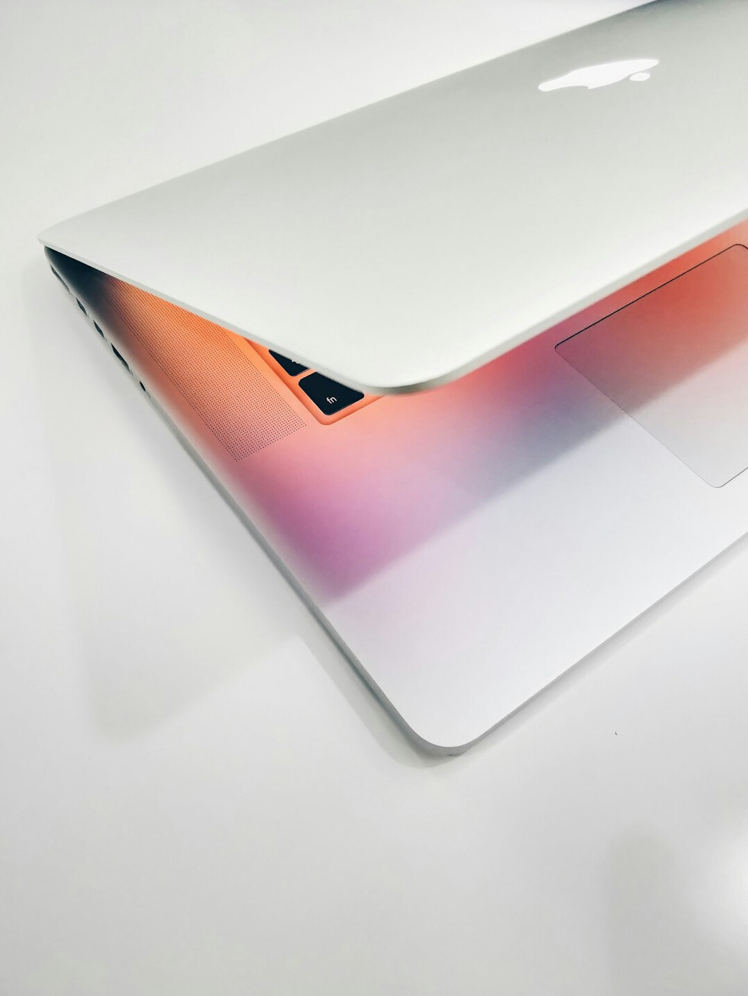 Laptop with analytics charts and a notebook on a desk