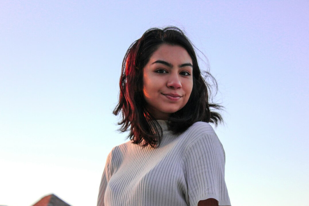 Portrait of a young woman with dark hair smiling
