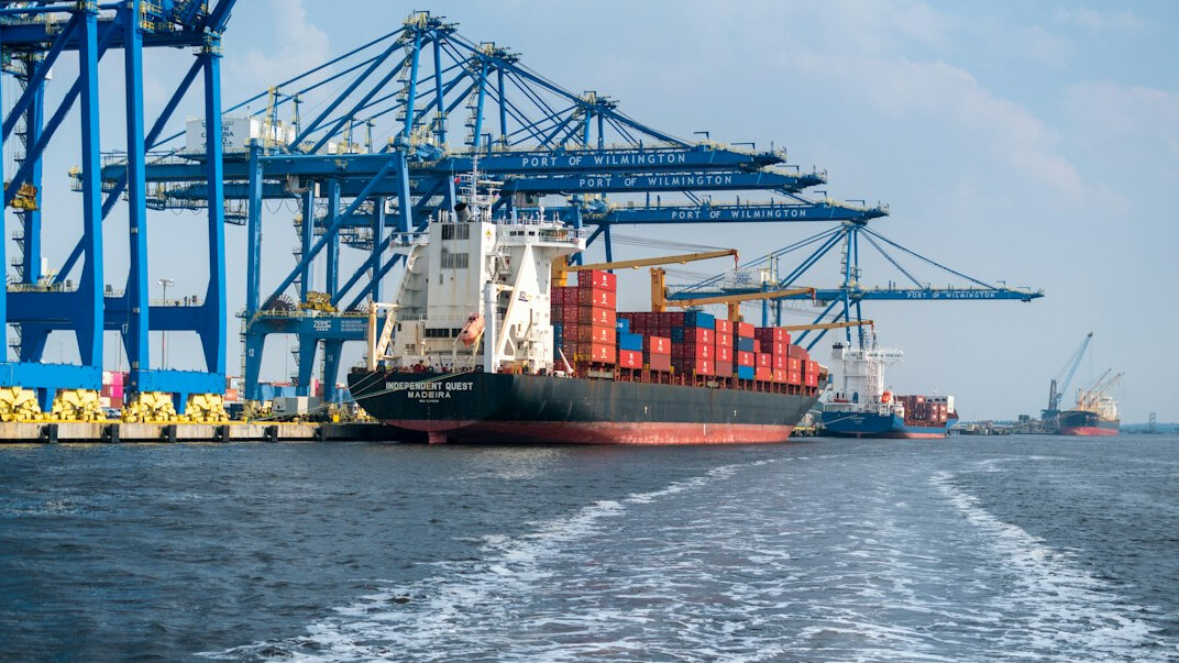 Container port with stacked shipping containers and cranes